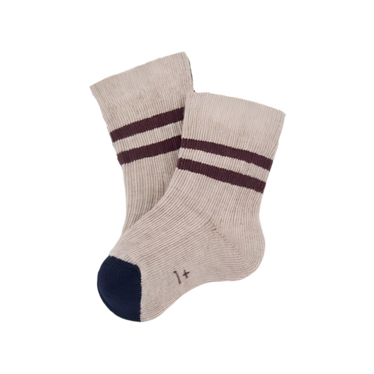 Pair of beige socks with brown stripes on a white background