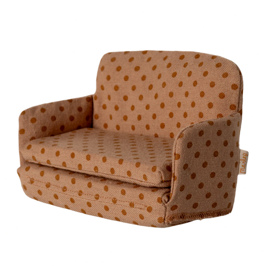 Brown polka dot armchair on a beige background