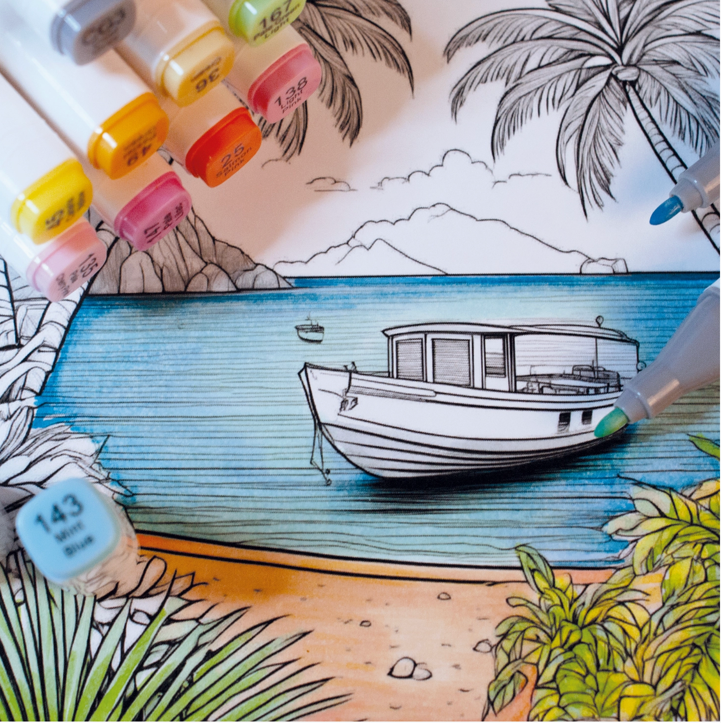 Coloring book page with a boat and beach scene, markers on the side.
