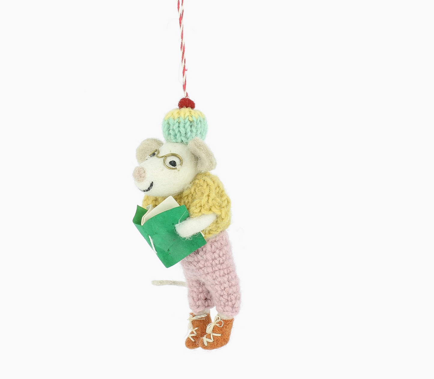 Knitted mouse ornament holding a book on a white background