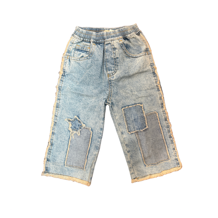 Pair of distressed jeans on a wooden surface