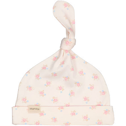 A beige newborn cap with a floral pattern, made of modal, organic cotton, and elastane, by Marmar Copenhagen.