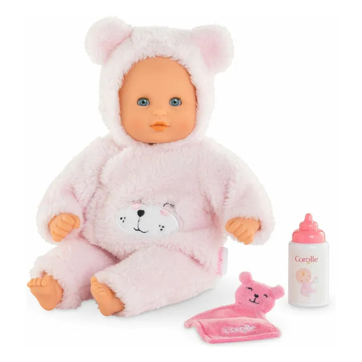 Baby doll in a pink bear costume with accessories on a white background